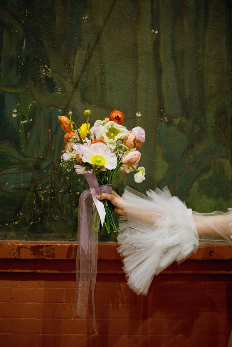 Photo of a bride holding her bouquet taken by Parker