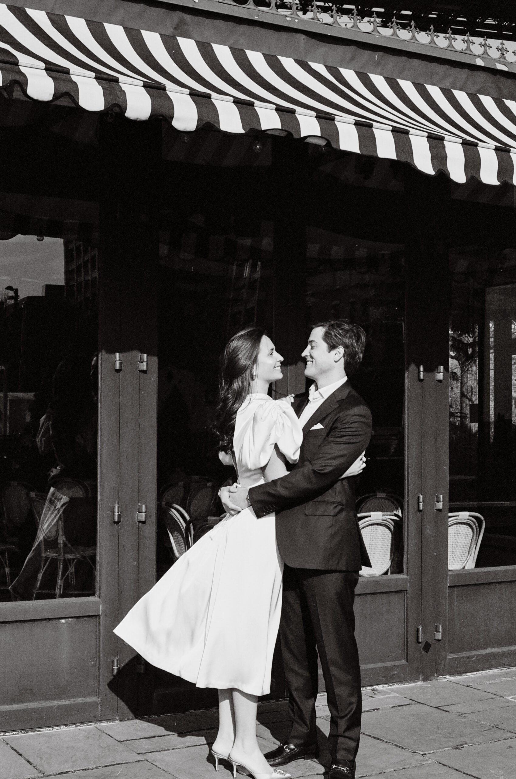 couple embracing in brooklyn bridge park engagement photo at the river cafe shot on film by parkers pictures