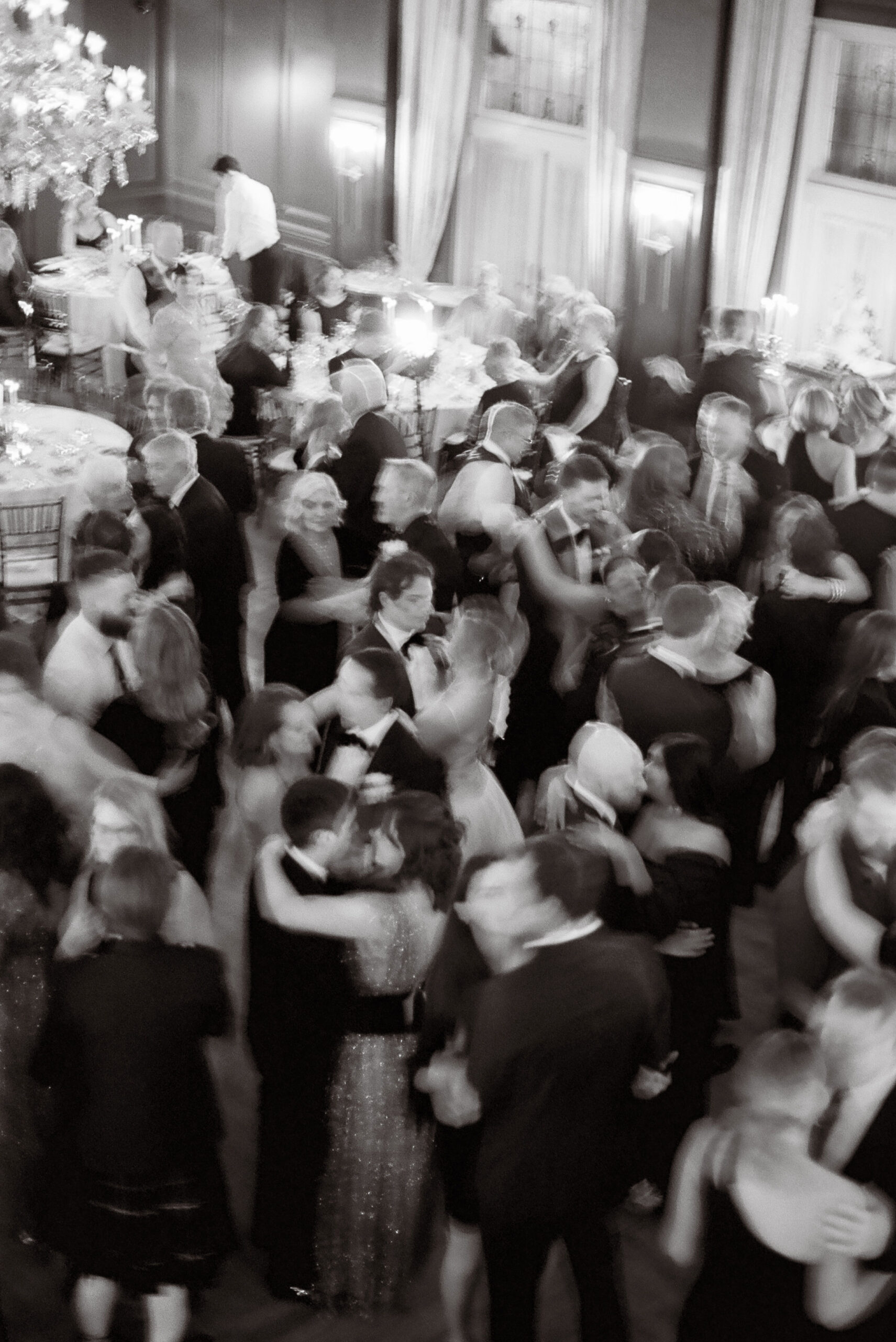 couples in motion on the dance floor at a wedding shot on black and white film by parkers pictures