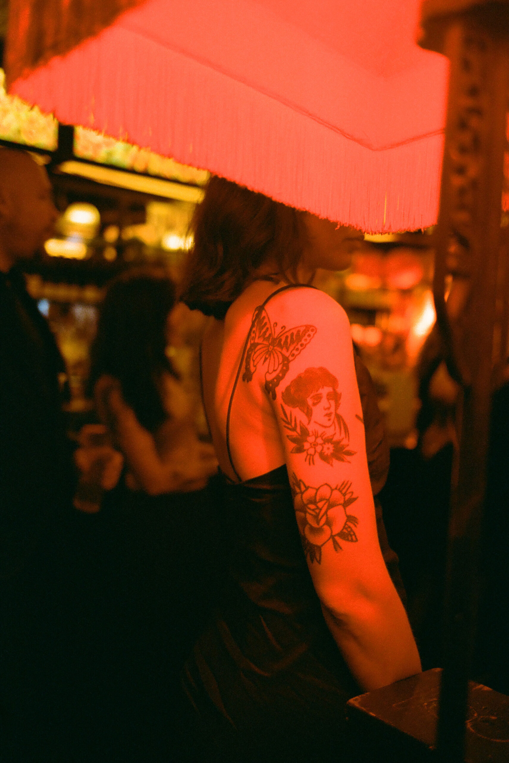 red light on tattooed wedding guest shot on 35mm film by parkers pictures